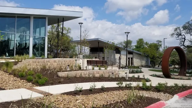 a view of a swimming pool with a patio and a garden