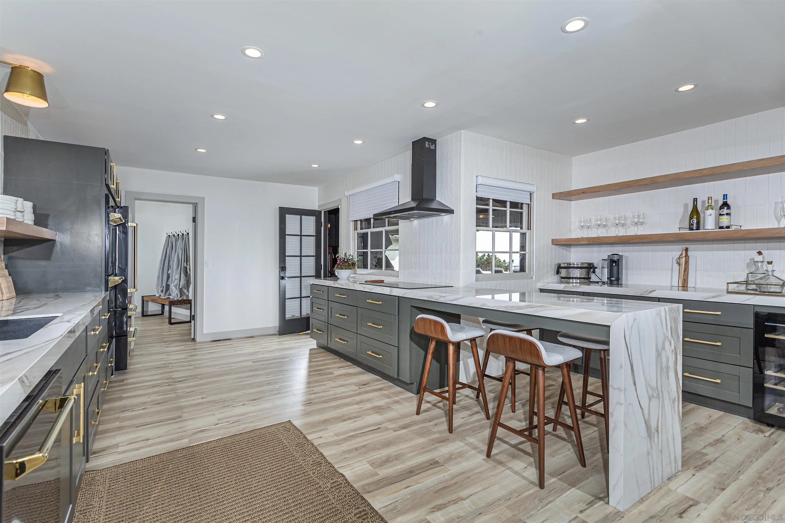 7362 Brodiaea Way La Jolla, CA 92037 - Photo 15 of 31 a kitchen with stainless steel appliances granite countertop a sink a stove a refrigerator and island with wooden floor