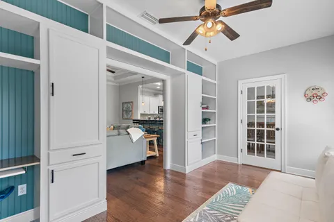a view of a livingroom with wooden floor and furniture