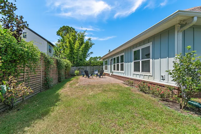 a view of a house with backyard and sitting area