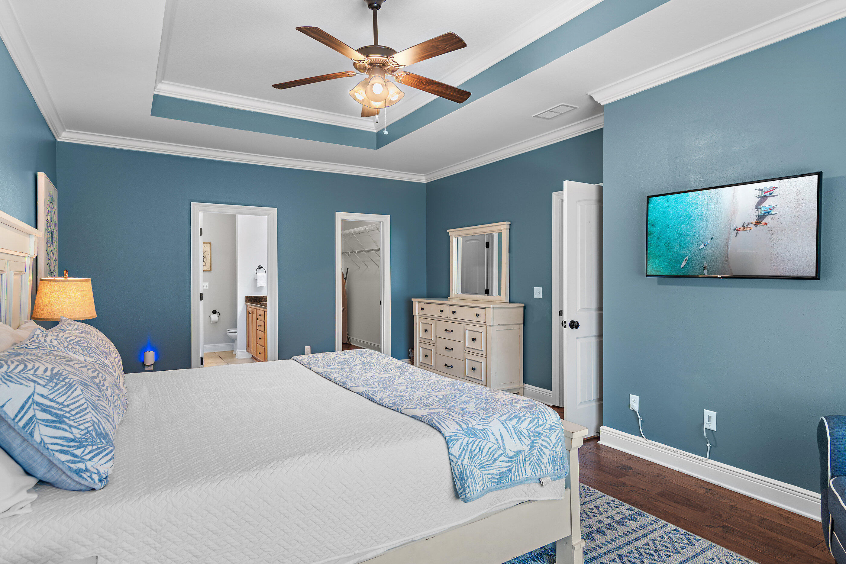 166 Ocean Spray Circle Santa Rosa Beach, FL 32459 - Photo 20 of 31 a bedroom with a large bed and a chandelier