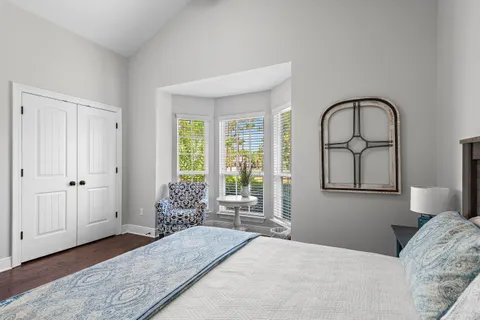 a bedroom with a bed and a large window