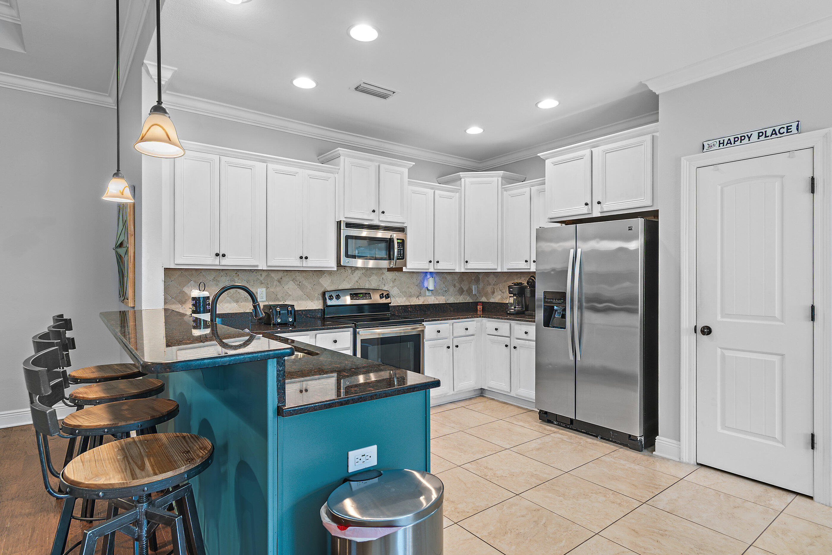 166 Ocean Spray Circle Santa Rosa Beach, FL 32459 - Photo 8 of 31 a kitchen with stainless steel appliances granite countertop a sink a stove a refrigerator cabinets and chairs