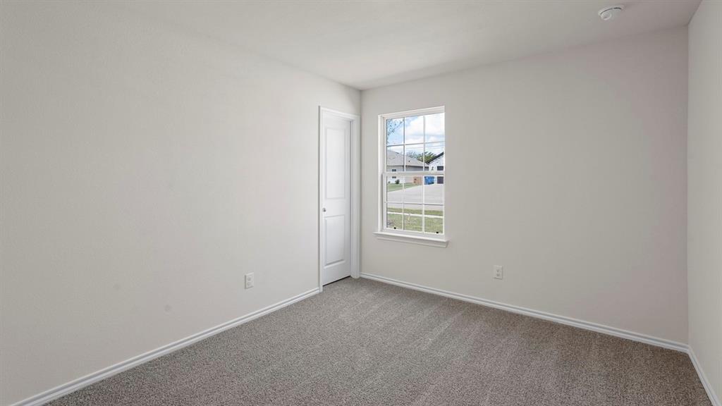 1675 Mantle Road Crandall, TX 75114 - Photo 18 of 27 Interior space featuring light gray carpeting, white baseboards, and neutral wall paint