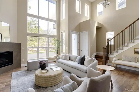 a living room with furniture large window and a fireplace