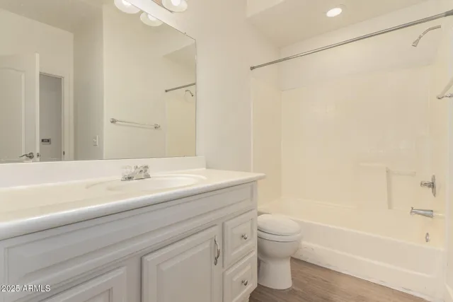 a bathroom with a granite countertop sink a toilet and a bathtub