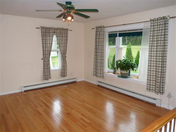 79 Mine Brook Road Webster, MA 01570 - Photo 10 of 30 a view of an empty room with wooden floor and a window