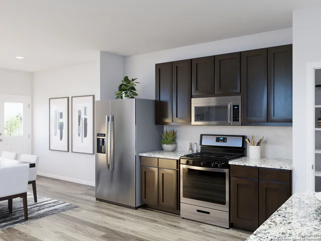 a kitchen with a table and chairs in it