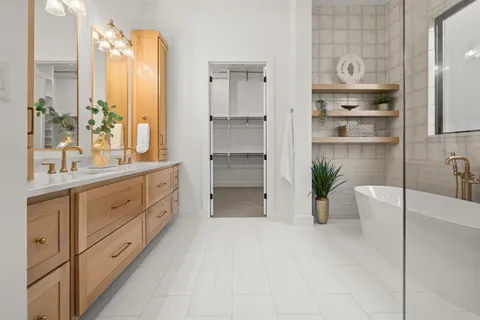a spacious bathroom with a double vanity sink and a bathtub
