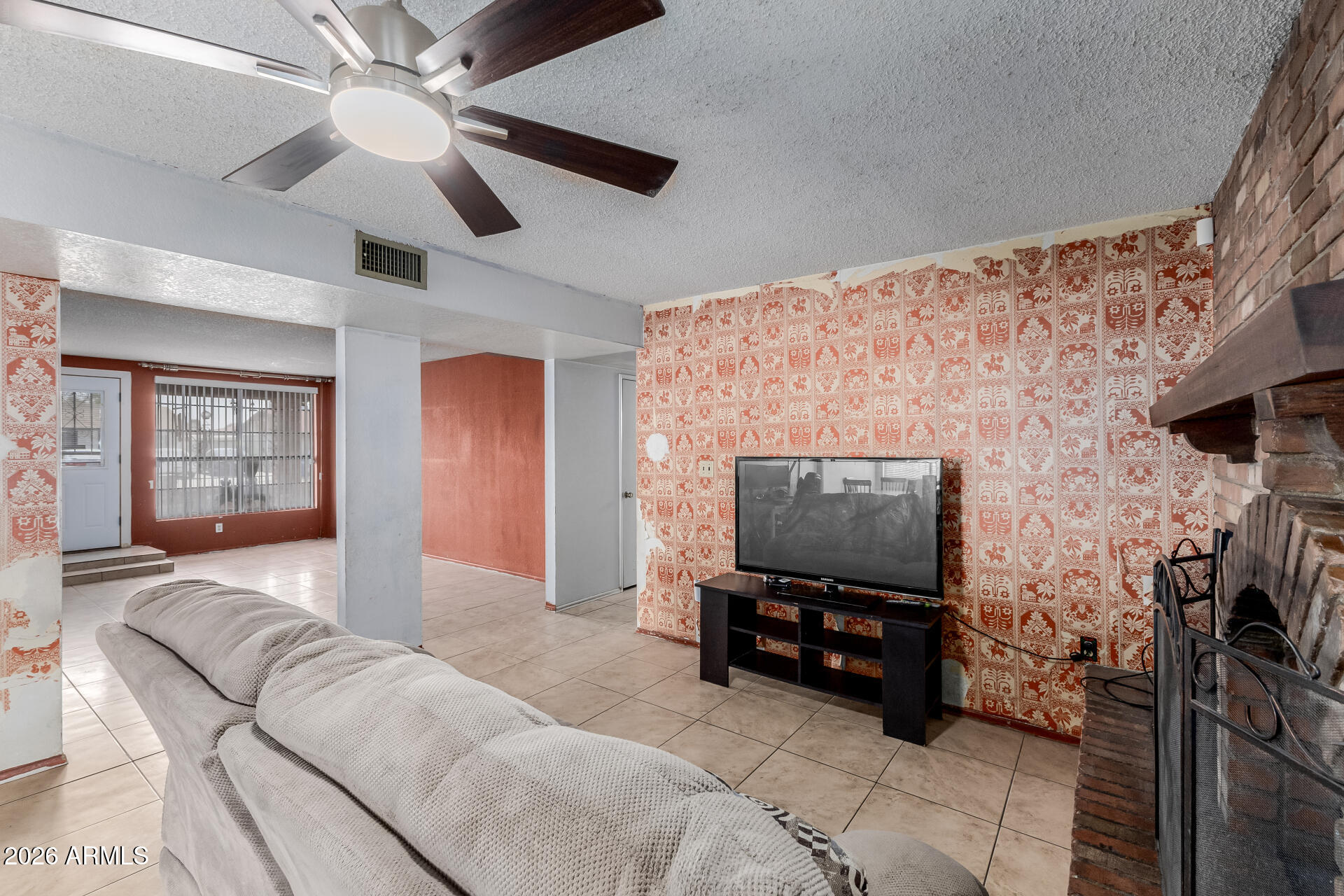 7708 West Flower Street Phoenix, AZ 85033 - Photo 13 of 35 a living room with furniture and a flat screen tv