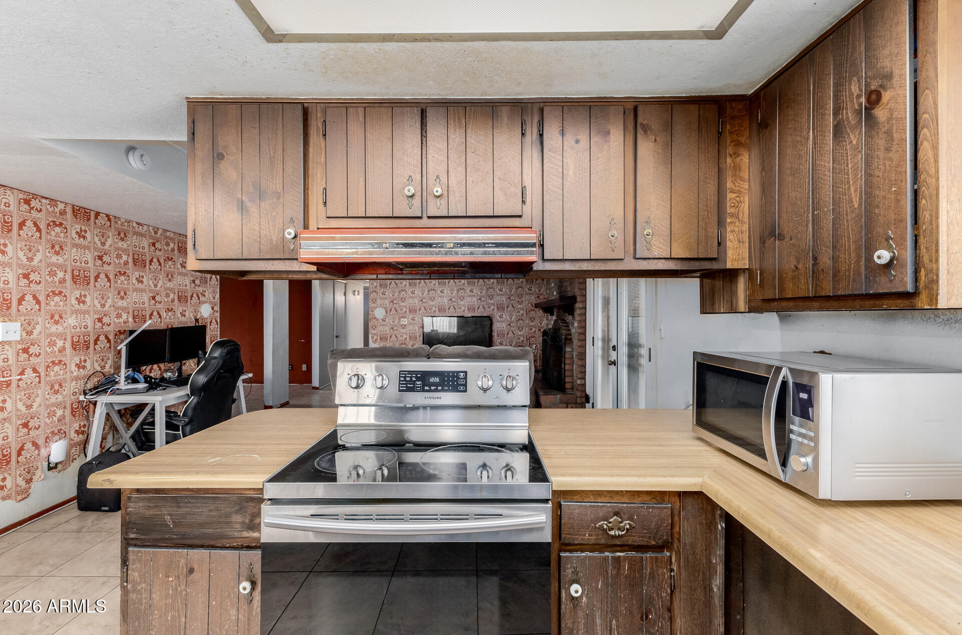 7708 West Flower Street Phoenix, AZ 85033 - Photo 18 of 35 a stove top oven sitting inside of a kitchen