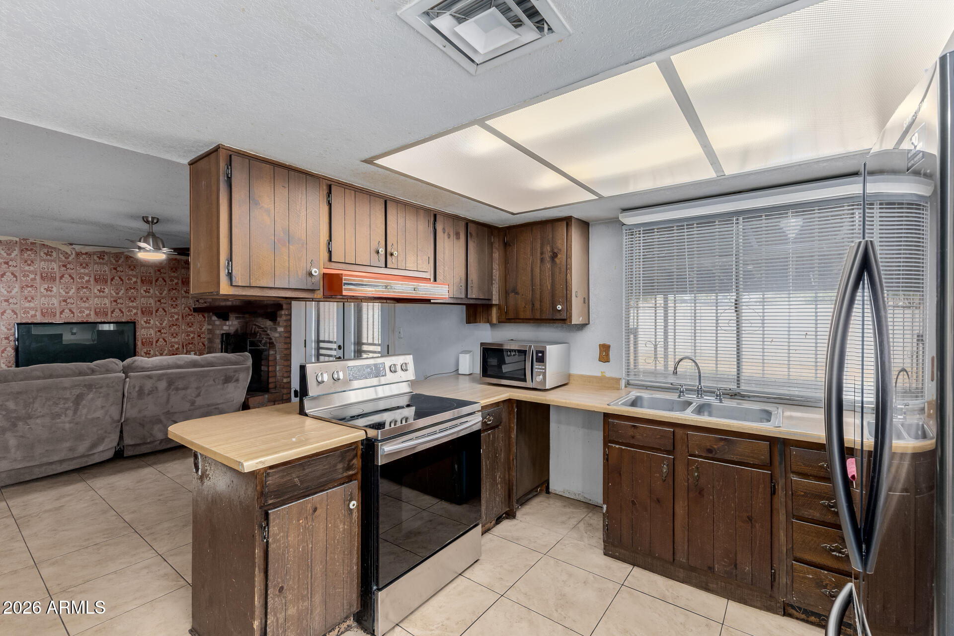 7708 West Flower Street Phoenix, AZ 85033 - Photo 19 of 35 a kitchen with a sink a stove top oven and cabinets