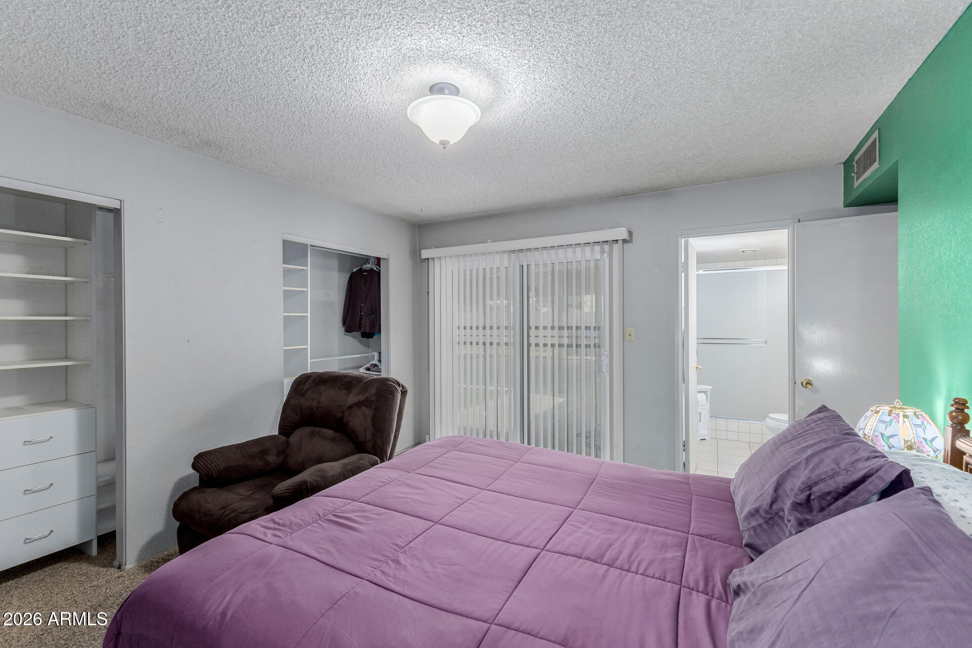 7708 West Flower Street Phoenix, AZ 85033 - Photo 20 of 35 a bedroom with a bed and wooden floor