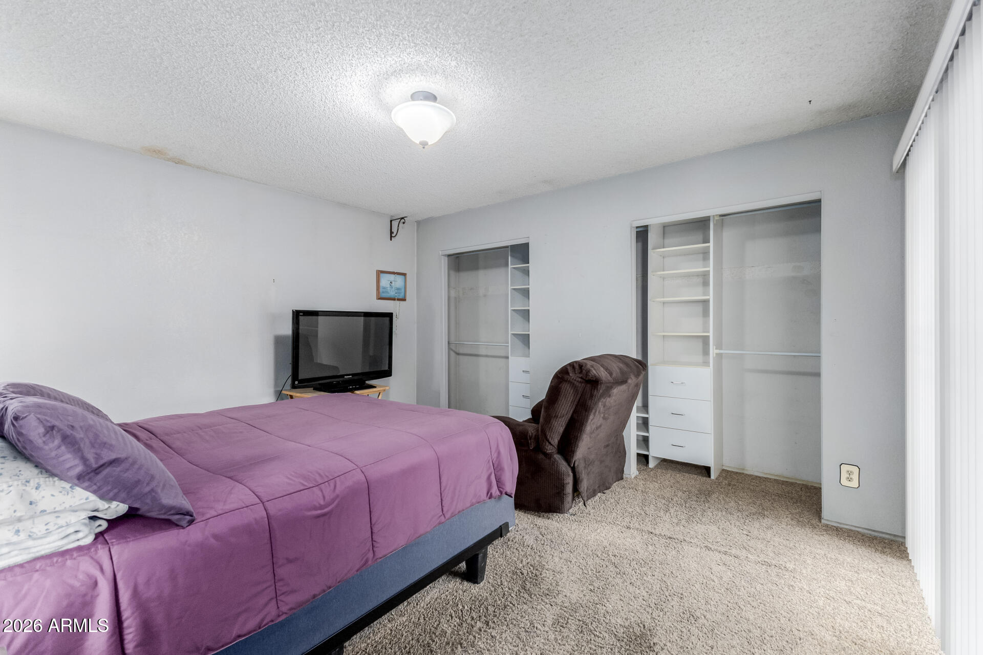 7708 West Flower Street Phoenix, AZ 85033 - Photo 22 of 35 a bedroom with a bed and a chair