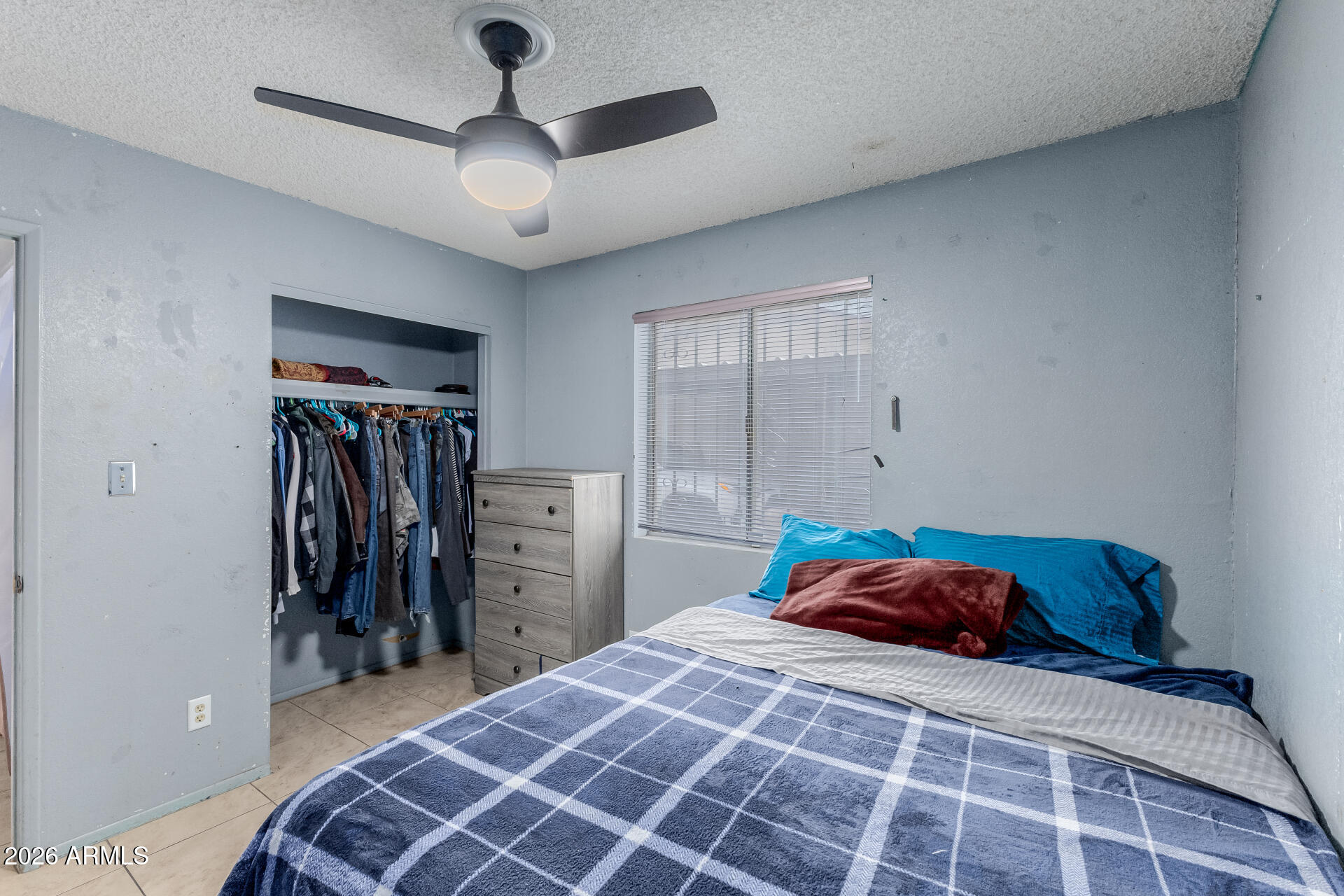 7708 West Flower Street Phoenix, AZ 85033 - Photo 25 of 35 a bedroom with a large bed and a chandelier