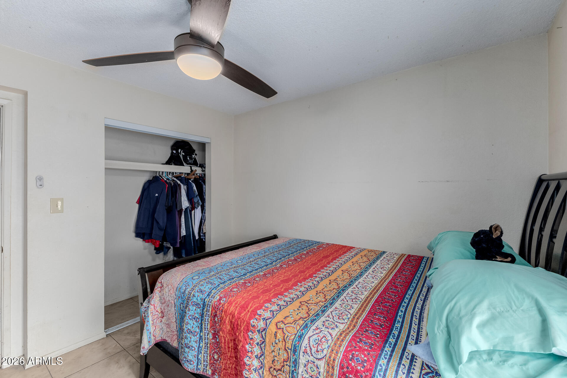 7708 West Flower Street Phoenix, AZ 85033 - Photo 30 of 35 a bedroom with a bed and a walk in closet