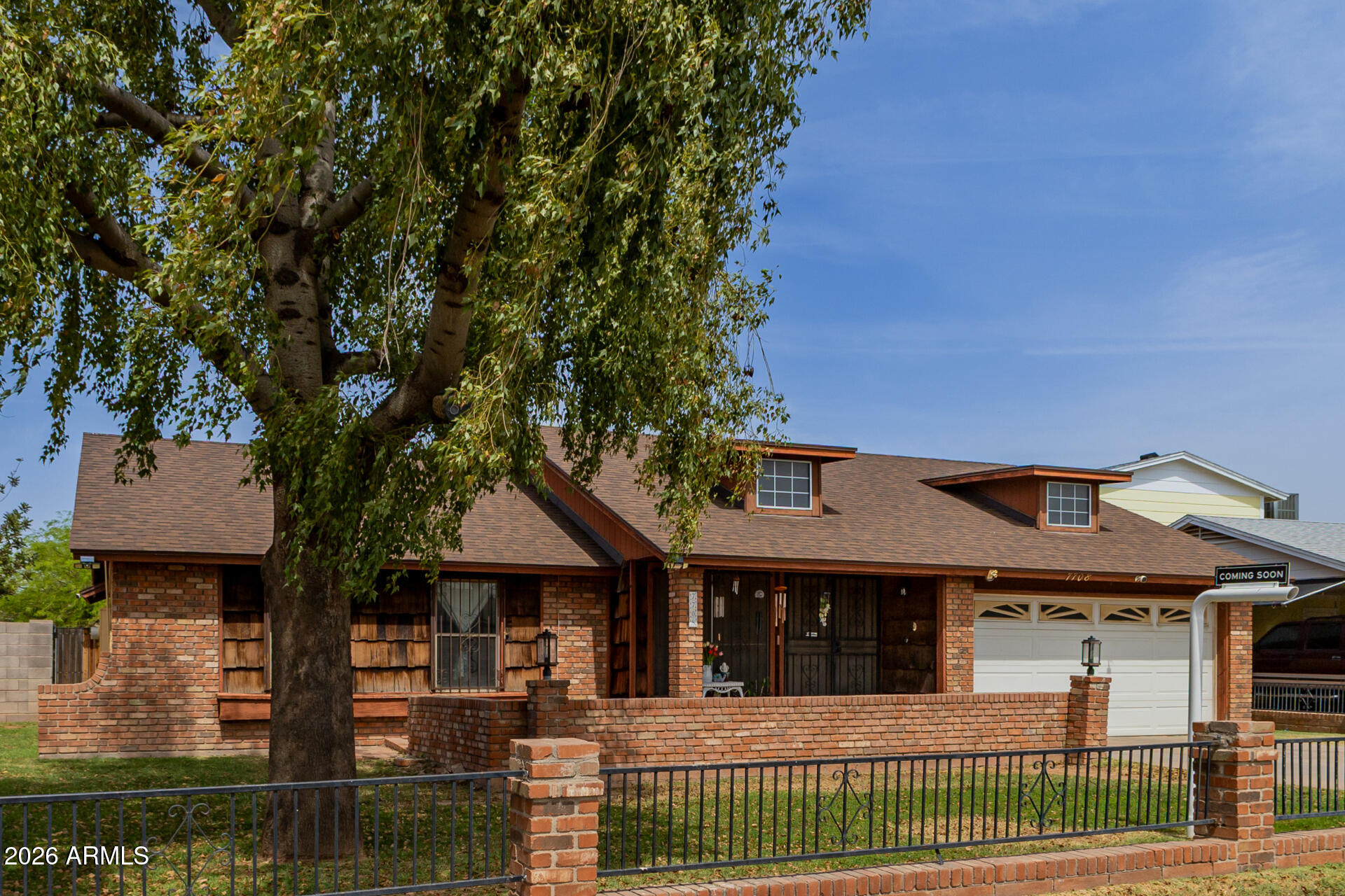 7708 West Flower Street Phoenix, AZ 85033 - Photo 5 of 35 a front view of a house with a tree
