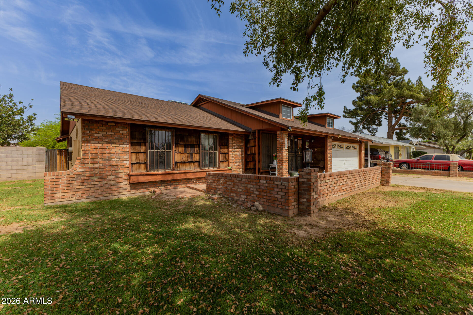 7708 West Flower Street Phoenix, AZ 85033 - Photo 7 of 35 a front view of a house with a yard