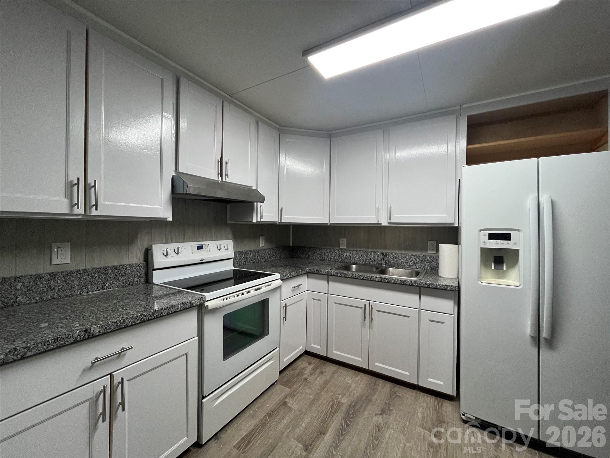 4723 Linden Street Columbia, SC 29203 - Photo 1 of 8 a kitchen with cabinets stainless steel appliances a sink and wooden floor