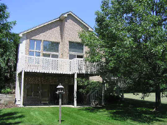 6383 Spring Brook Road Rockford, IL 61114 - Photo 5 of 6 a view of a house with a yard and a garden