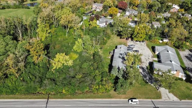 an aerial view of a residential houses with yard