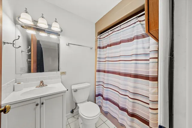 a view of a hallway with wooden floor and stairs