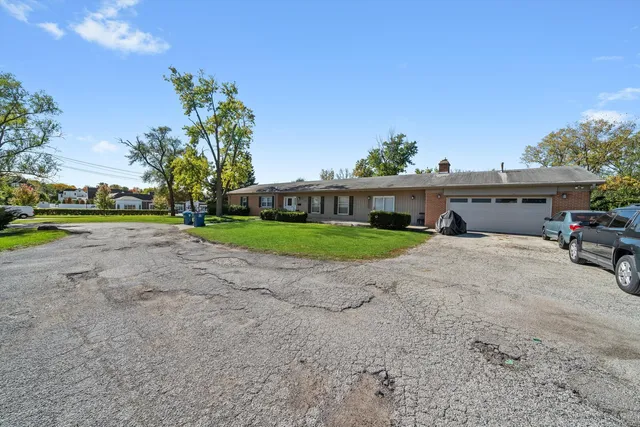 a view of a house with a yard and sitting area