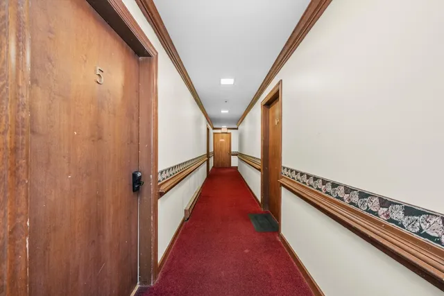 a living room with furniture a rug and a window