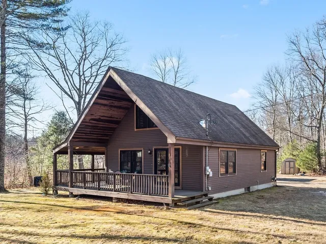 a view of a house with large pool and large trees