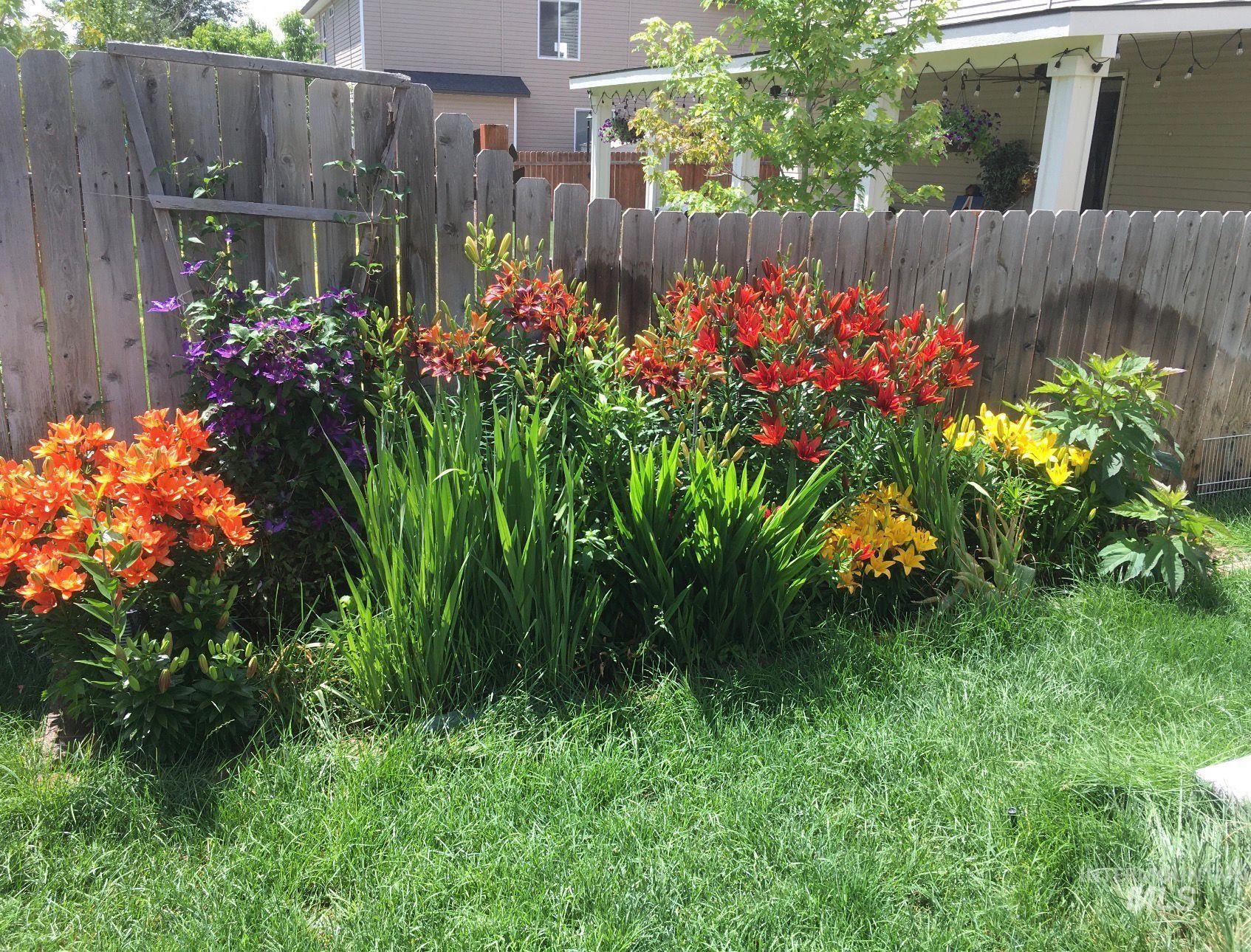 1555 Condor Drive Middleton, ID 83644 - Photo 49 of 50 Garden bed featuring a variety of flowering plants including orange, red, yellow, and purple blooms