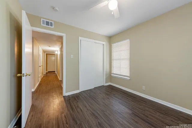 a view of hallway with wooden floor