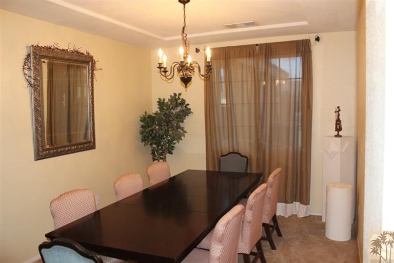83317 Wagon Road Indio, CA 92203 - Photo 2 of 17 a view of a dining room with furniture and wooden floor