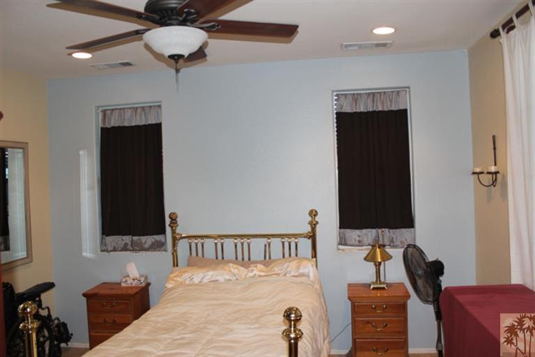 83317 Wagon Road Indio, CA 92203 - Photo 9 of 17 a bedroom with a bed and a flat tv screen