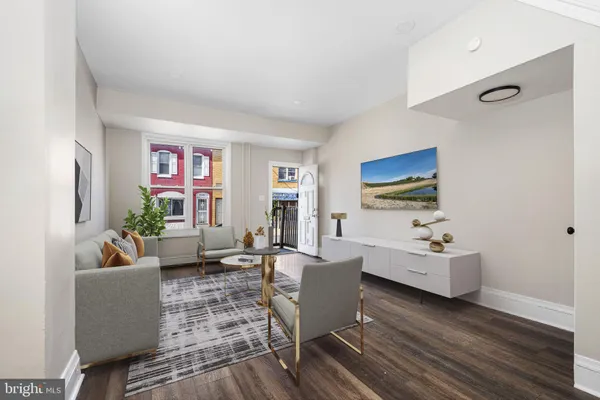 a living room with furniture wooden floor and a flat screen tv