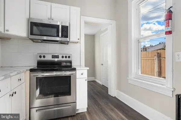 a kitchen with a stove and a microwave