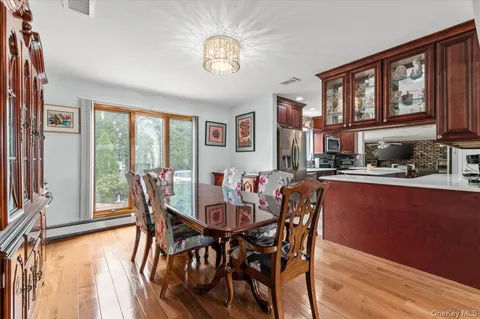 a view of a dining room with furniture a chandelier and wooden floor