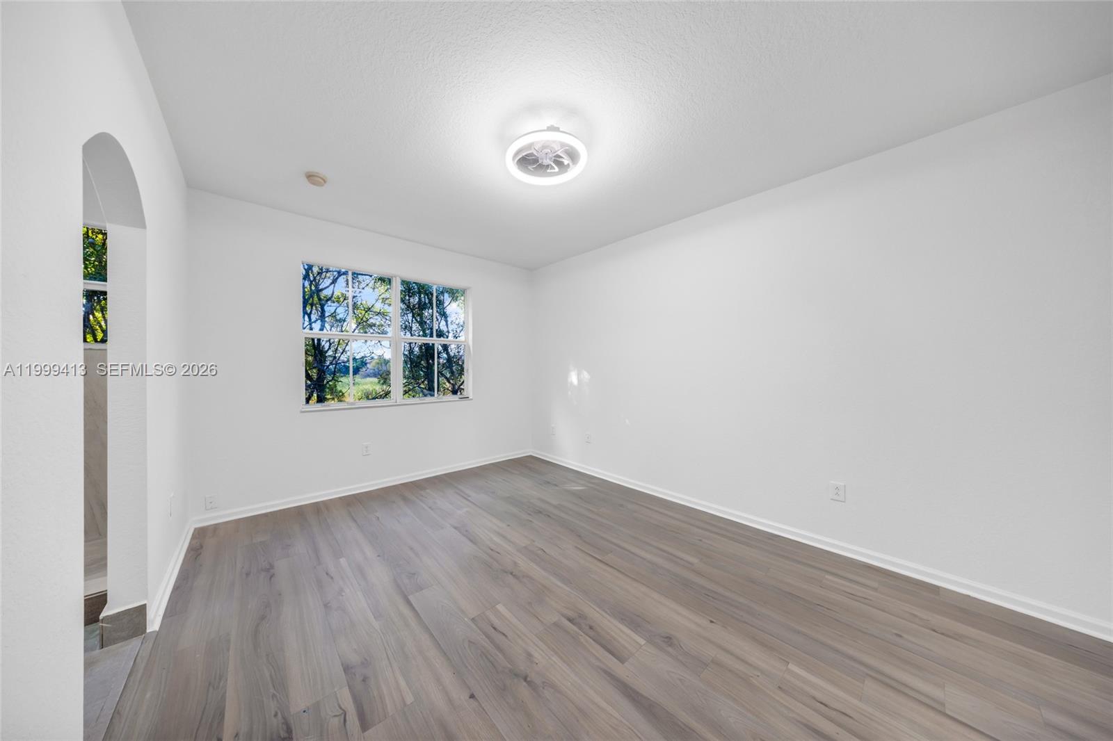 12040 Southwest 28th Street, Unit 4064 Miramar, FL 33025 - Photo 12 of 23 an empty room with wooden floor and windows