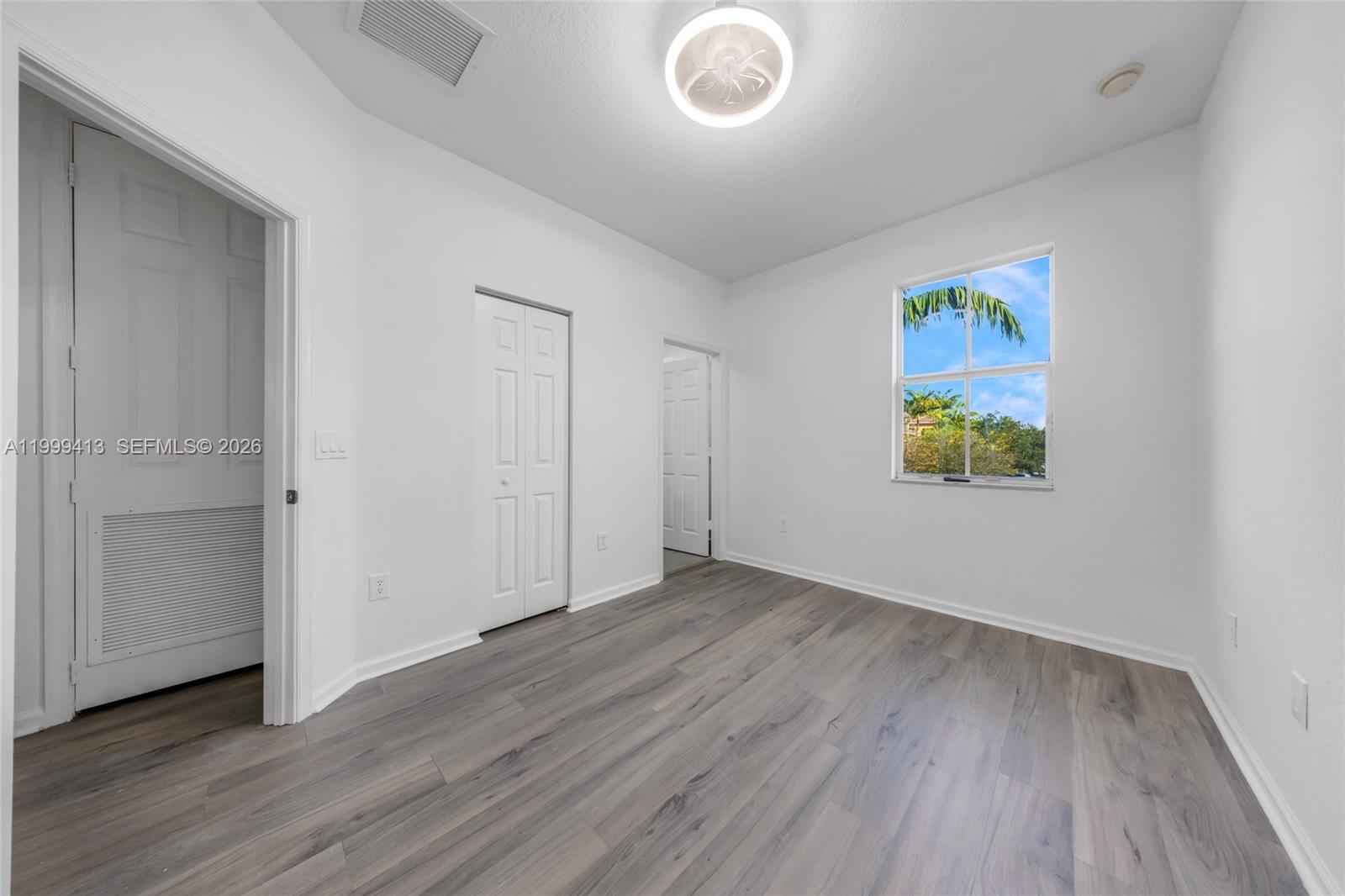 12040 Southwest 28th Street, Unit 4064 Miramar, FL 33025 - Photo 18 of 23 a view of an empty room with wooden floor