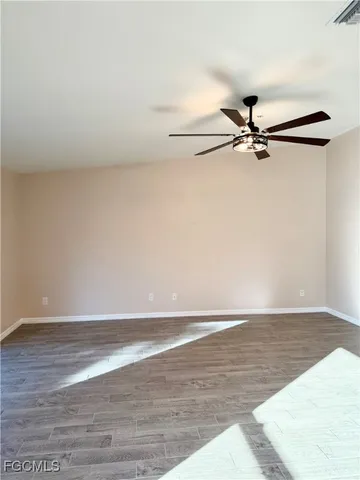 a view of a room with wooden floor and white walls