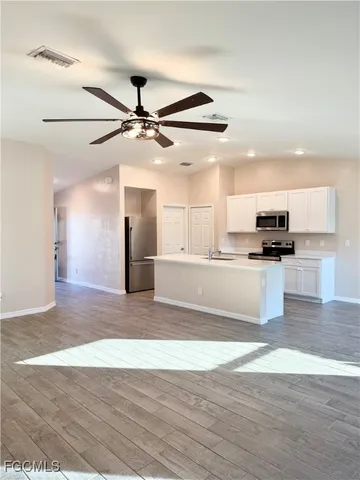 a view of kitchen with granite countertop cabinets and wooden floor