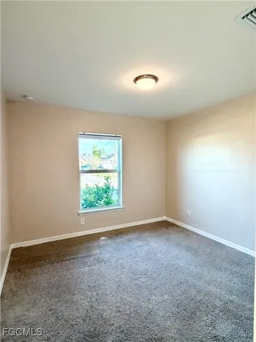 an empty room with a empty space and a window