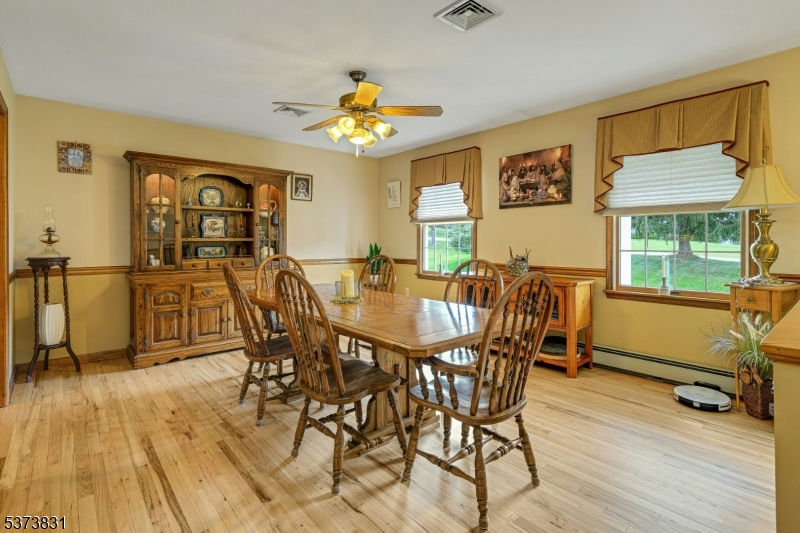 83 Hyatt Road Branchville, NJ 07826 - Photo 11 of 27 a view of a dining room with furniture a chandelier and wooden floor