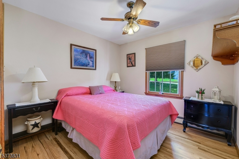 83 Hyatt Road Branchville, NJ 07826 - Photo 15 of 27 a bedroom with a bed a dresser and potted plant