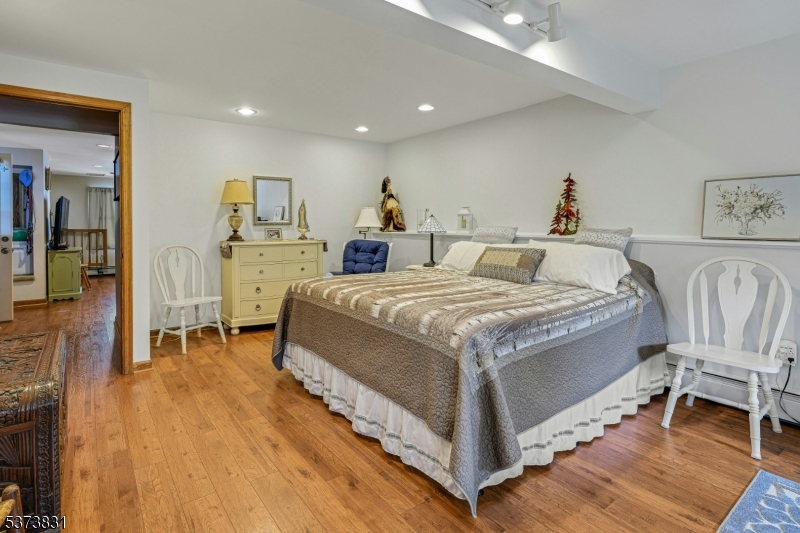 83 Hyatt Road Branchville, NJ 07826 - Photo 23 of 27 a spacious bedroom with a bed and a table in it