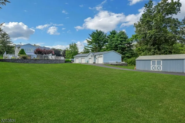 a view of a house with a backyard