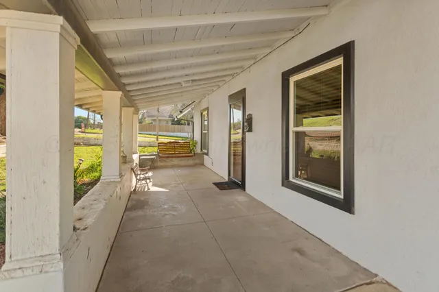 a hallway with a wooden floor and a bathroom