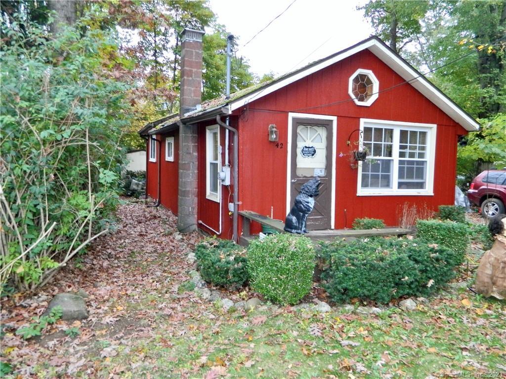 42 Richard Road Guilford, CT 06437 - Photo 1 of 1 a front view of a house with garden