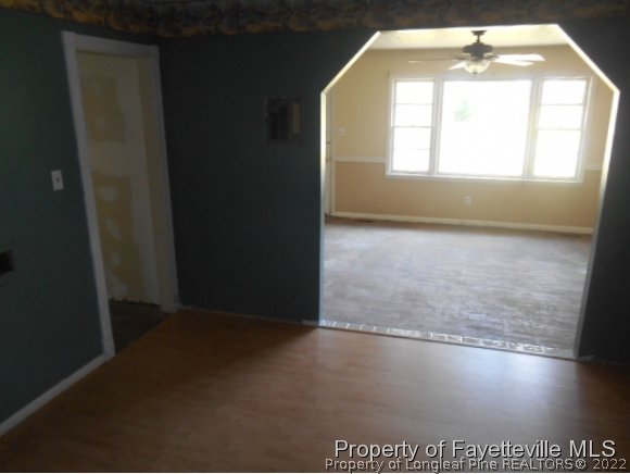3255 Hayes Mill Road Godwin, NC 28344 - Photo 5 of 11 an empty room with wooden floor and windows