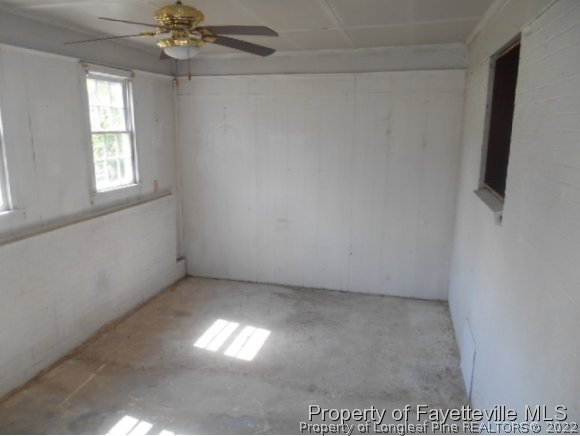 3255 Hayes Mill Road Godwin, NC 28344 - Photo 9 of 11 en empty room with windows and chandelier fan