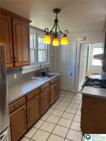 a kitchen with stainless steel appliances a stove a sink and a microwave